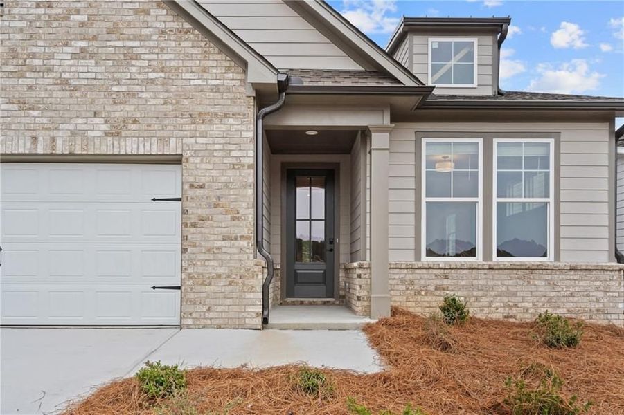 Front exterior of a new home in Kelly Preserve, Loganville, GA, highlighting curb appeal (Image 7).