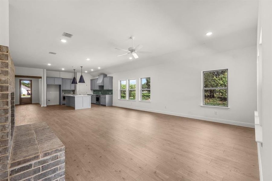 Unfurnished living room with flooring, recessed lighting, and ceiling fan