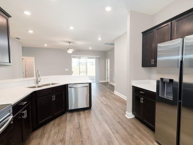 The kitchen includes a pantry and in-kitchen dining at the breakfast bar - Savannah by Highland Homes