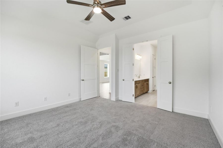 Additional view from primary bedroom looking towards the double door entrance to primary bathroom.