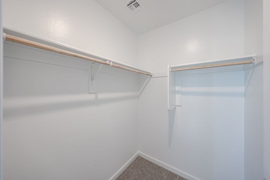 A white hallway with a metal railing. A white hallway with a metal railing.