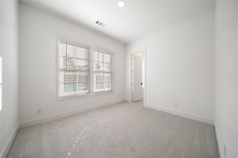 Spare room featuring light carpet