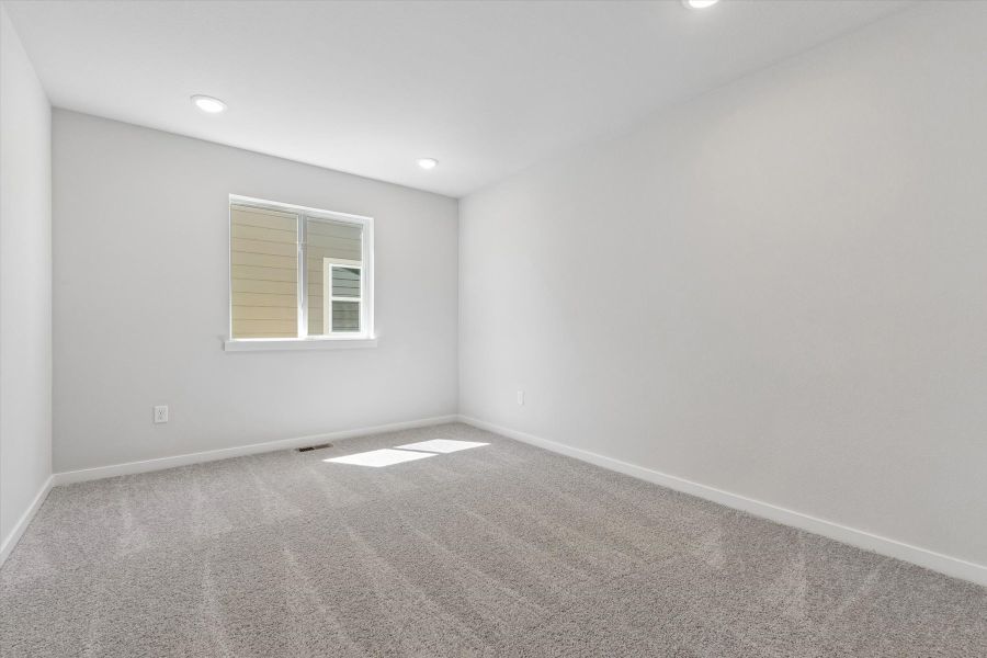 A room with a window and a rug. A room with a window and a rug.