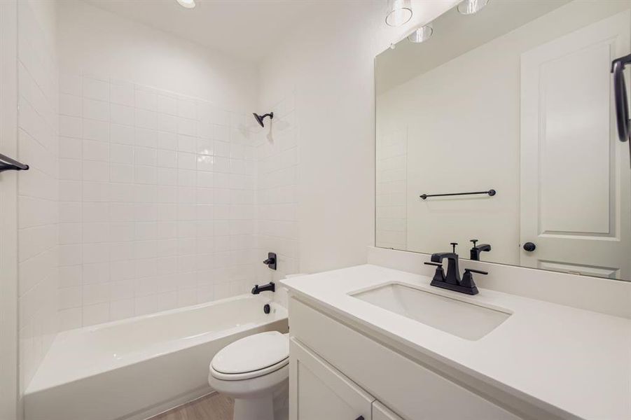 Bathroom with bathing tub / shower combination and vanity Bathroom with bathing tub / shower combination and vanity