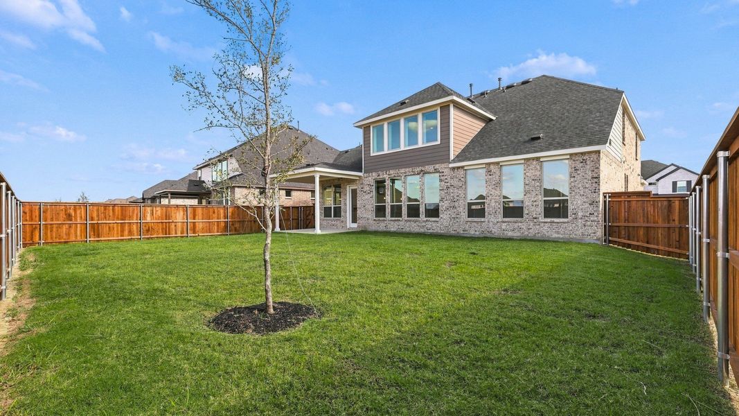 Exterior details and patio area of a home in Green Meadows Classic, Celina (Image 25).