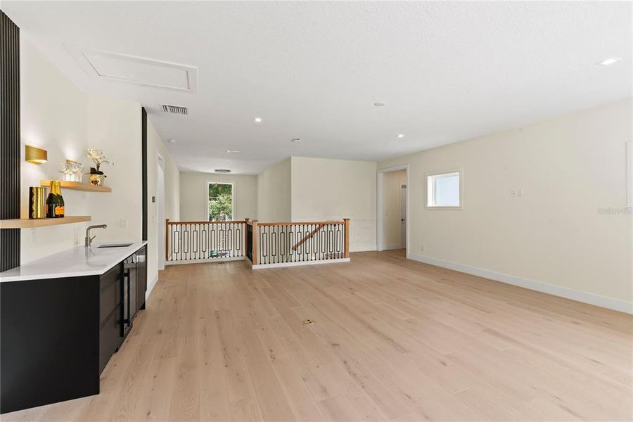 Upstairs loft with wet bar with beverage fridge and sliding glass doors leading to the balcony overlooking the beautiful backyard Upstairs loft with wet bar with beverage fridge and sliding glass doors leading to the balcony overlooking the beautiful backyard