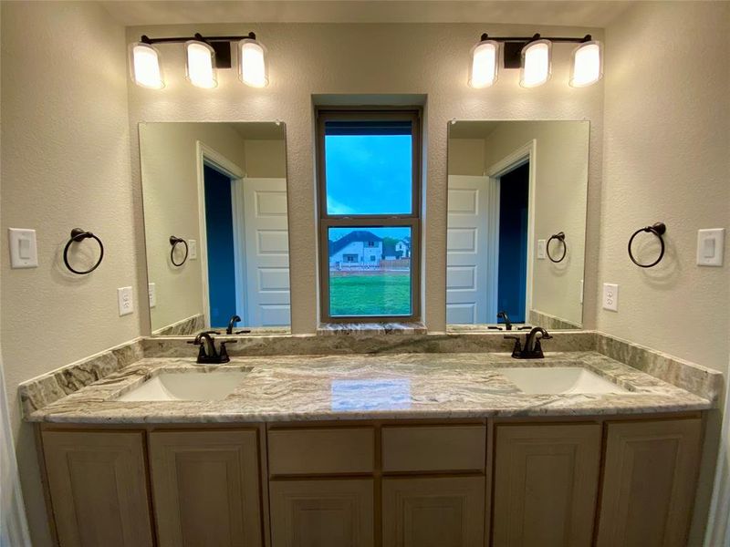Jack & Jill bath 3 has separate dual dink vanity area with a window that makes in much easier to share