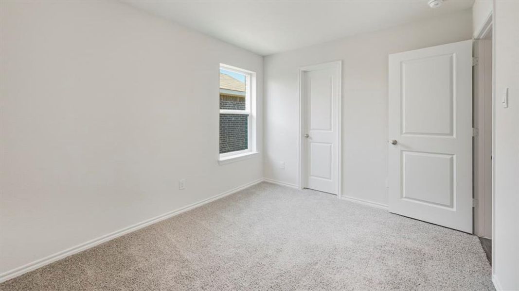 Unfurnished bedroom featuring light colored carpet and a closet