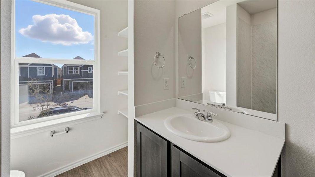Bathroom featuring vanity and dark wood finished floors