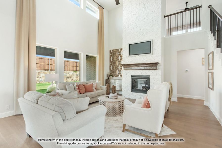Living room with two-story ceiling, white stone fireplace, and hardwood floors Living room with two-story ceiling, white stone fireplace, and hardwood floors