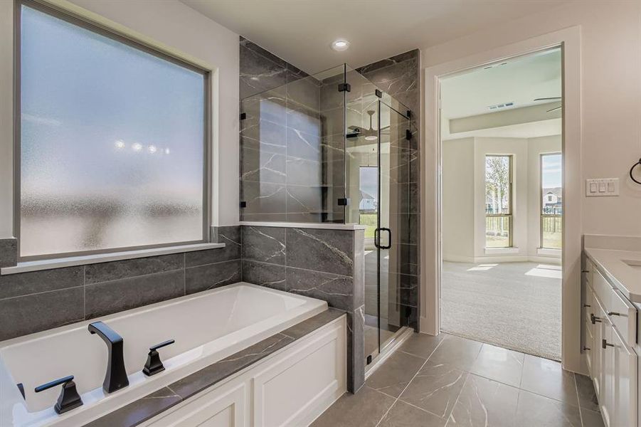 Full bath featuring a bath, vanity, a shower stall, and recessed lighting