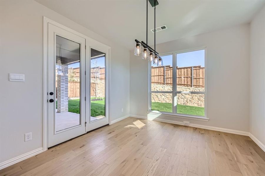 Unfurnished dining area featuring a wealth of natural light and light wood-type flooring