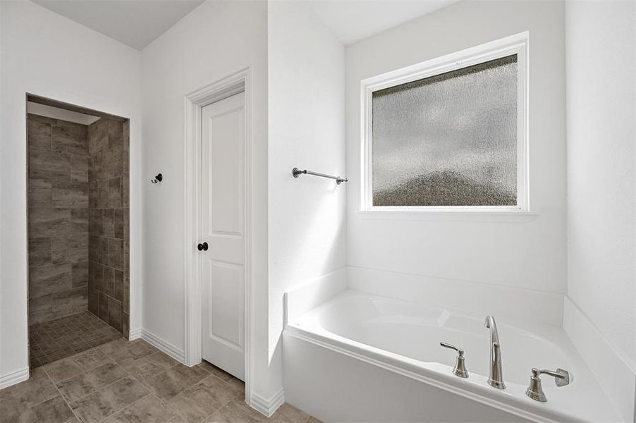 Bathroom featuring shower with separate bathtub