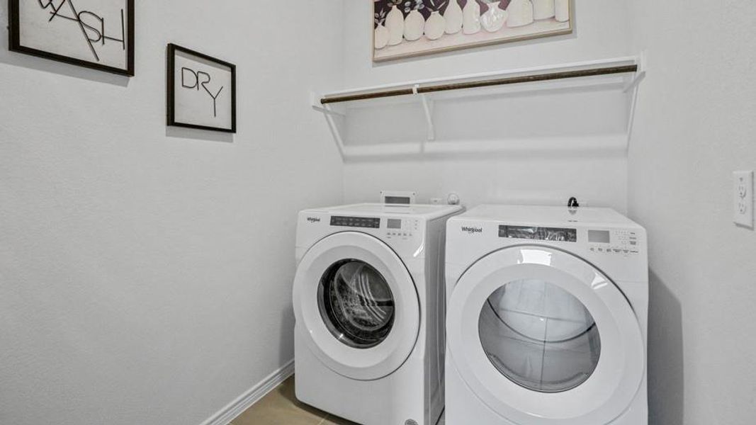 Laundry area featuring independent washer and dryer and tile patterned floors
