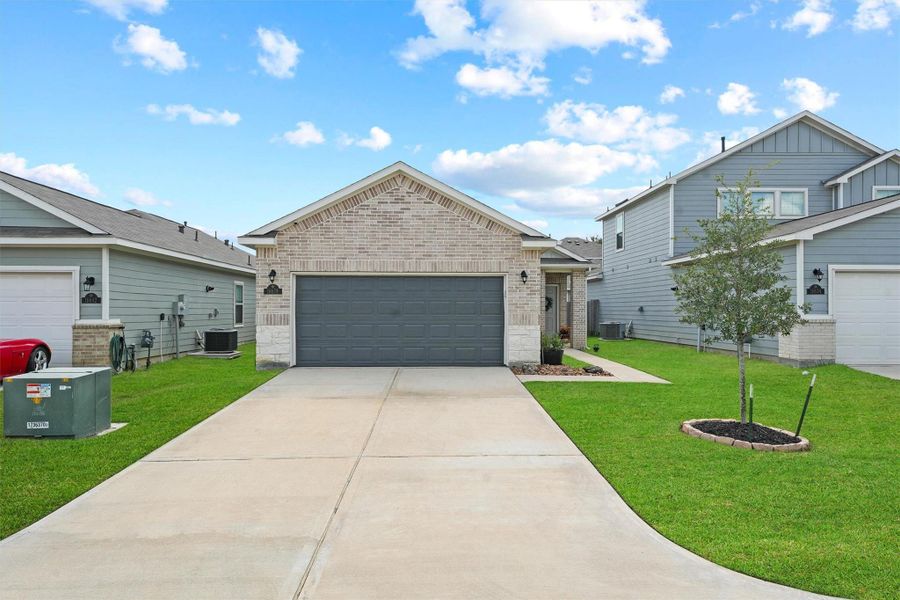 Front exterior of a new home in Maple Heights, Porter, TX, highlighting curb appeal (Image 2). Front exterior of a new home in Maple Heights, Porter, TX, highlighting curb appeal (Image 2).
