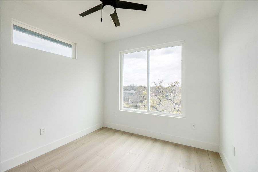 Spare room with light wood-style flooring and a ceiling fan