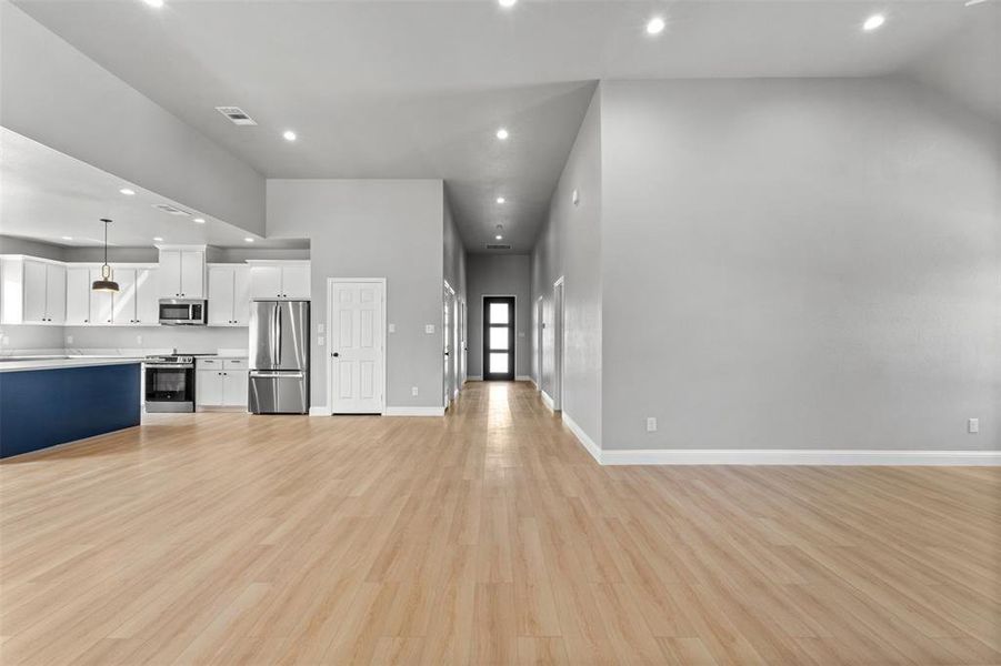 Unfurnished living room with recessed lighting and light wood finished floors