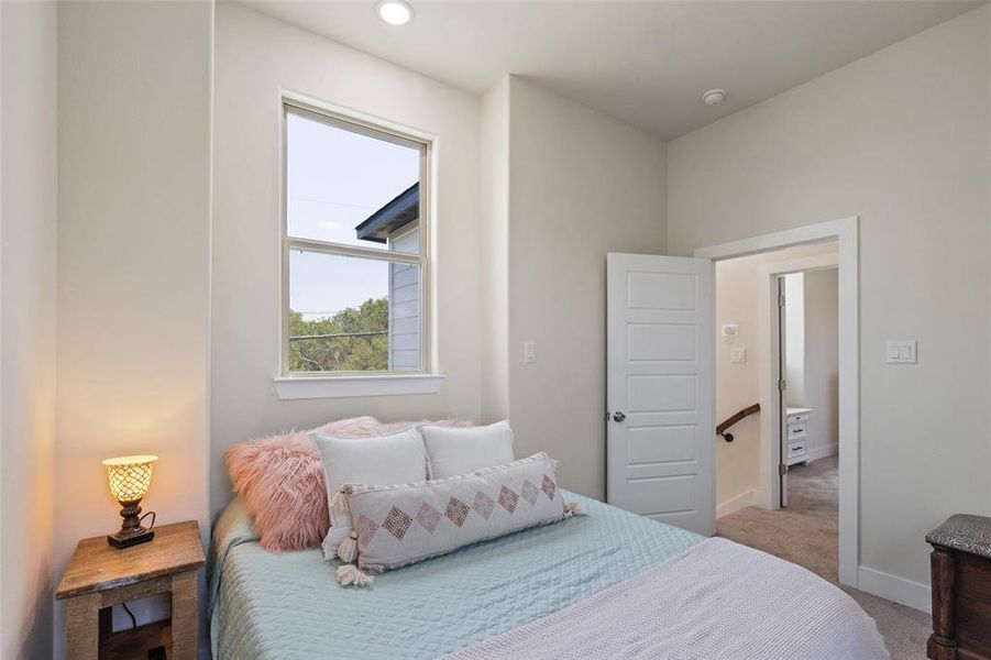 Upstairs bedroom featuring carpet