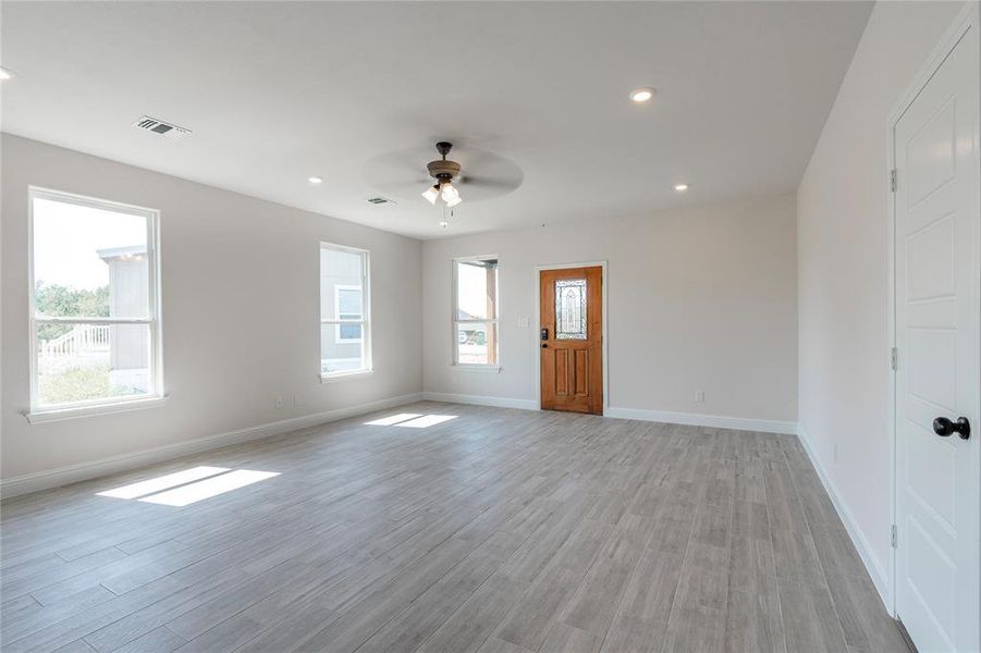 Empty room featuring ceiling fan and light wood-type flooring