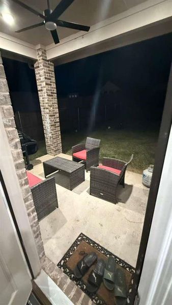 View of patio featuring ceiling fan and an outdoor living space