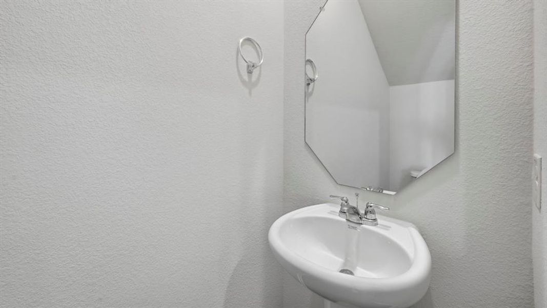 Half bathroom with a textured wall