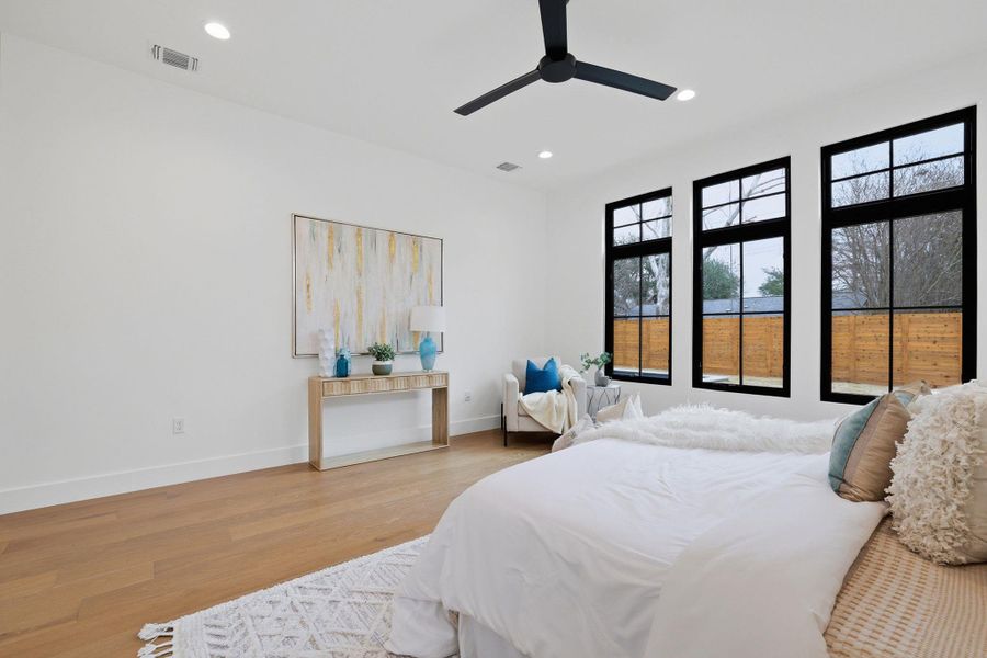 Bedroom with light wood-type flooring, a ceiling fan, and recessed lighting