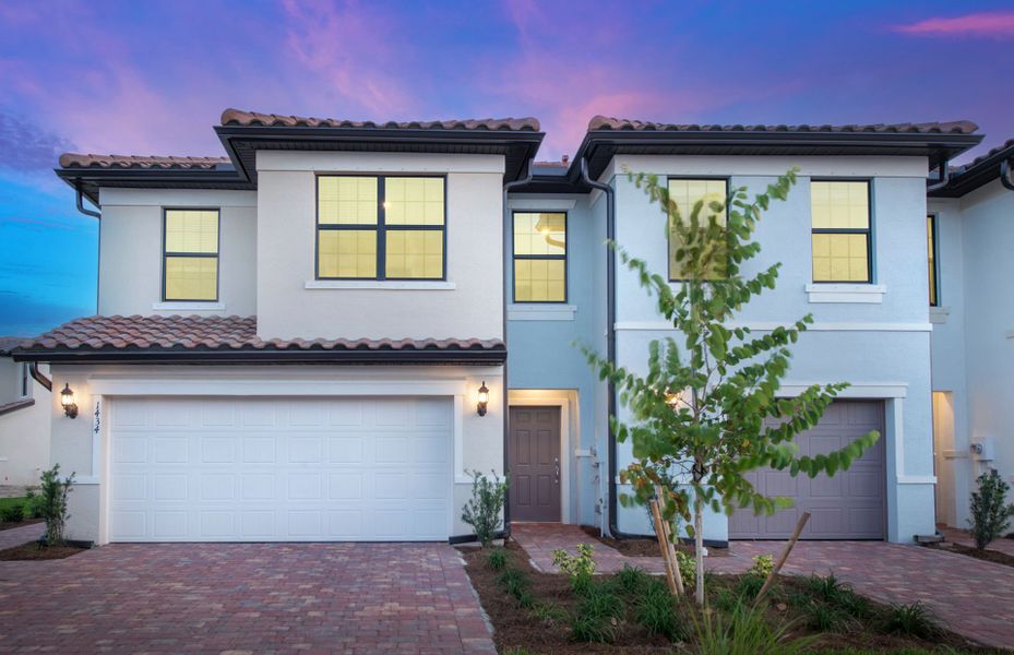 Front exterior of a new home in Sawgrass at Coral Lakes, Cape Coral, FL, highlighting curb appeal (Image 2). Front exterior of a new home in Sawgrass at Coral Lakes, Cape Coral, FL, highlighting curb appeal (Image 2).