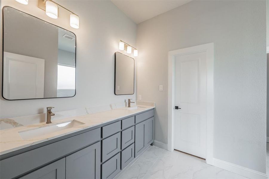 Gorgeous primary bath features double sinks with quartz counter tops & undermount sinks