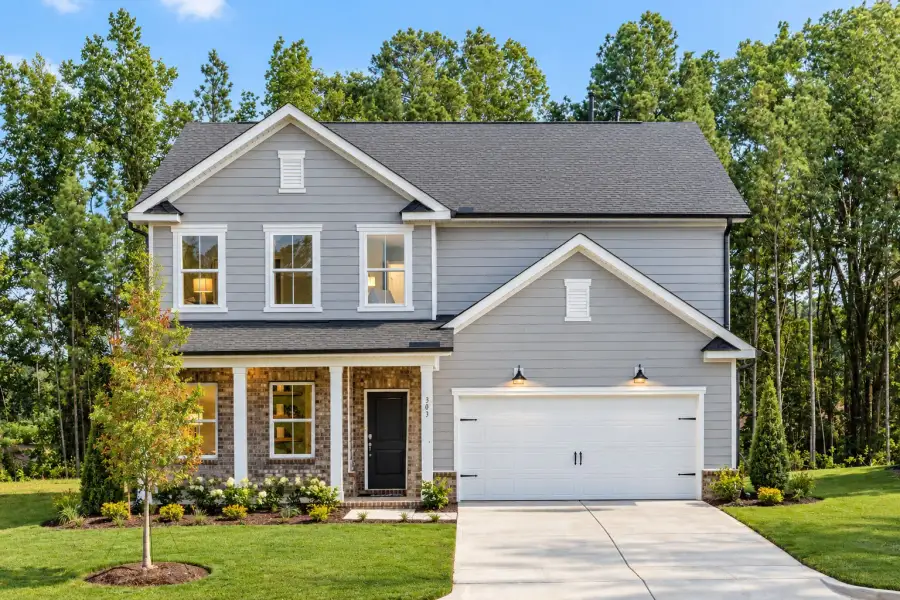 Front exterior of a new home in Exchange at 401, Raleigh, NC, highlighting curb appeal (Image 2). Front exterior of a new home in Exchange at 401, Raleigh, NC, highlighting curb appeal (Image 2).