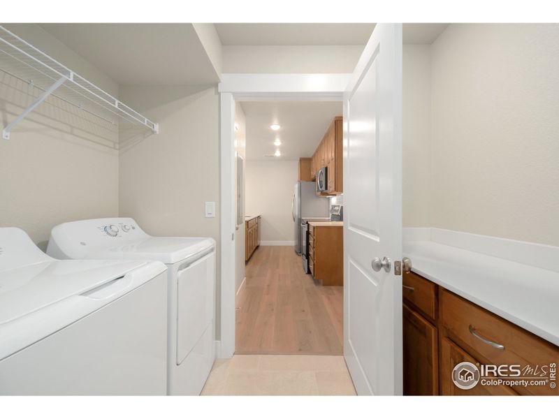 Full laundry room w/ built-in cabinets & quartz countertops