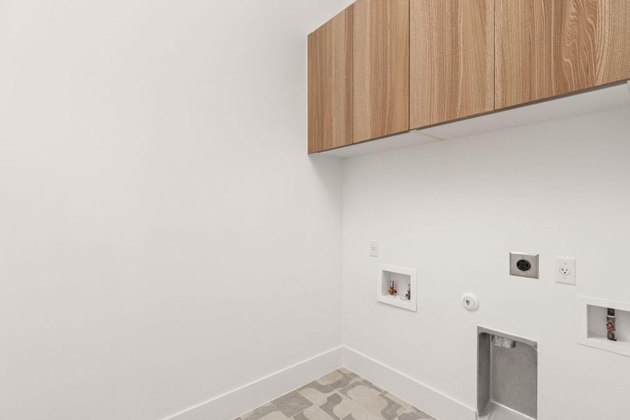 Laundry area with washer hookup, gas dryer hookup, cabinet space, and electric dryer hookup