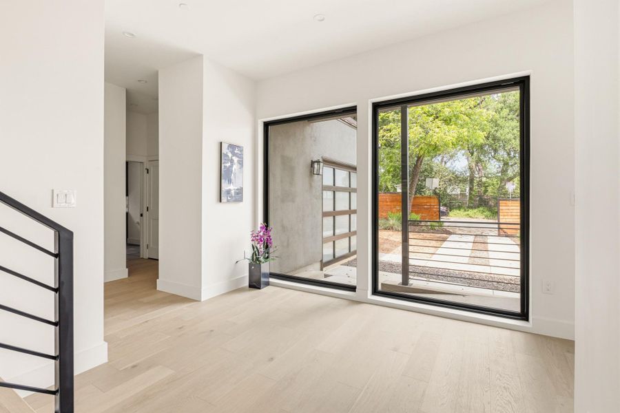 Bright interior space featuring light wood-finish flooring, white walls, and recessed lighting