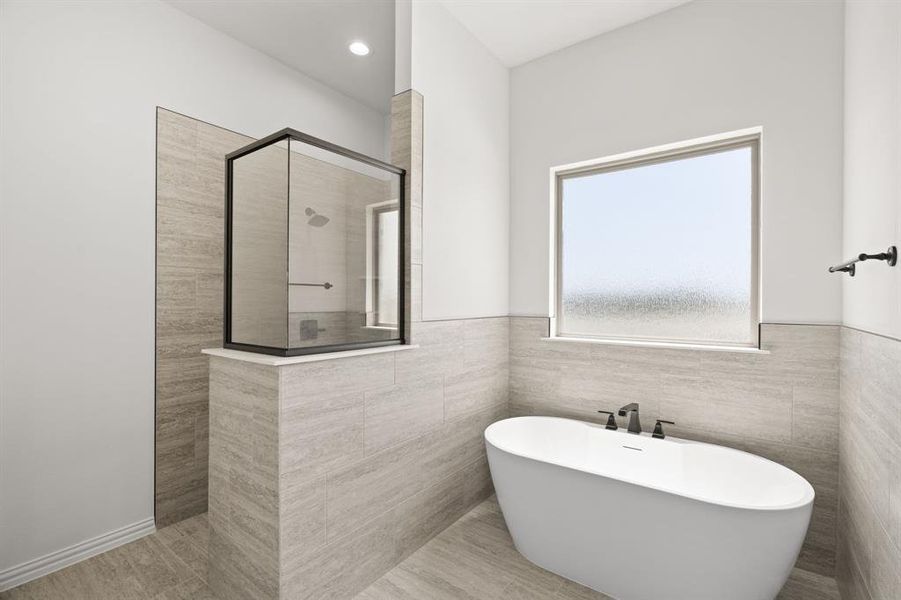 Full bath featuring a soaking tub, a stall shower, tile walls, and recessed lighting Full bath featuring a soaking tub, a stall shower, tile walls, and recessed lighting