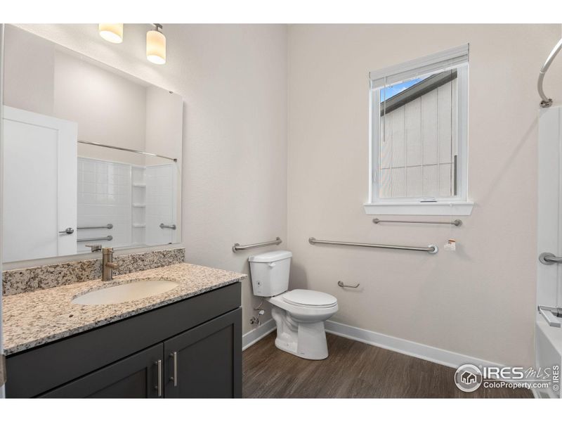 Main floor bathroom, with accessibility bars.