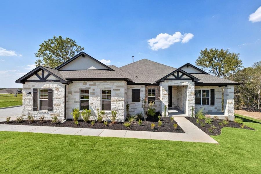 Front exterior of a new home in Double Eagle Ranch, Cedar Creek, TX, highlighting curb appeal (Image 1). Front exterior of a new home in Double Eagle Ranch, Cedar Creek, TX, highlighting curb appeal (Image 1).