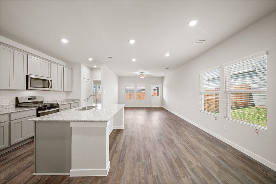 A kitchen with white cabinets.