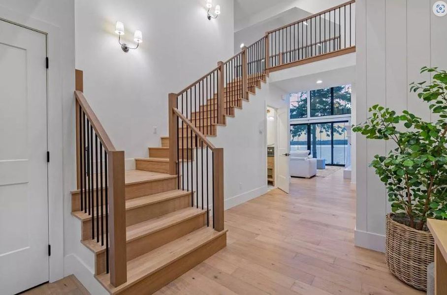 Entry with Black Iron Staircase with Luxury Vinyl Flooring., Ship Lap Walls