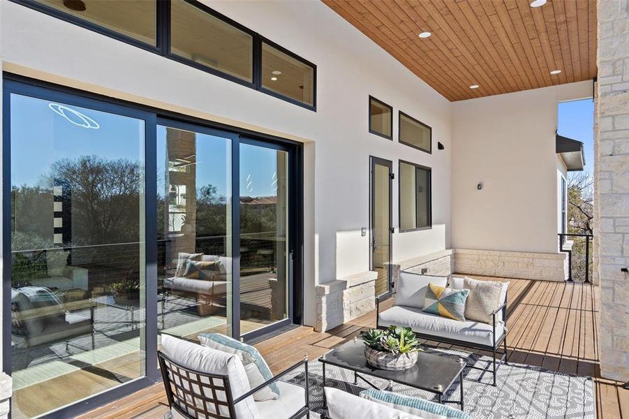 View of wooden balcony with outdoor lounge area and a wooden deck View of wooden balcony with outdoor lounge area and a wooden deck