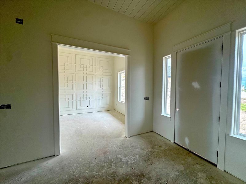 Geometric wainscoting and abundant natural light highlight this versatile space.