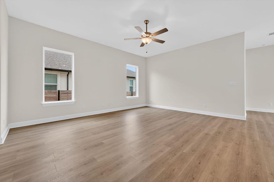 Unfurnished room with light wood-style floors and a ceiling fan