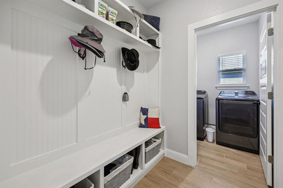 Mudroom with light wood finished floors and washer and clothes dryer Mudroom with light wood finished floors and washer and clothes dryer