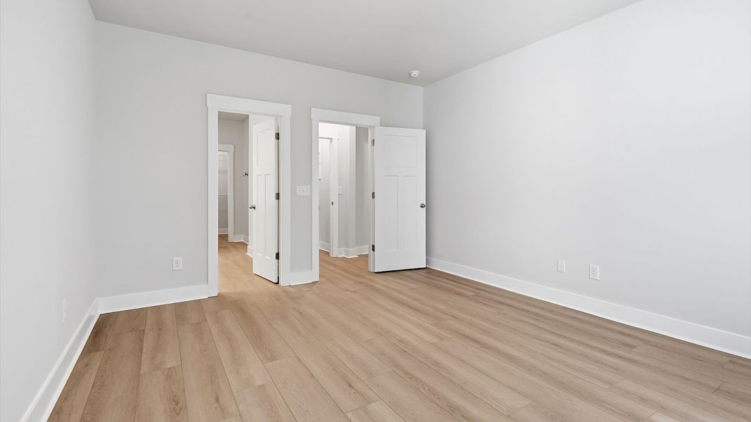 First-class hardwood floors and tasteful finishes elevate the private retreat of this exceptional primary suite