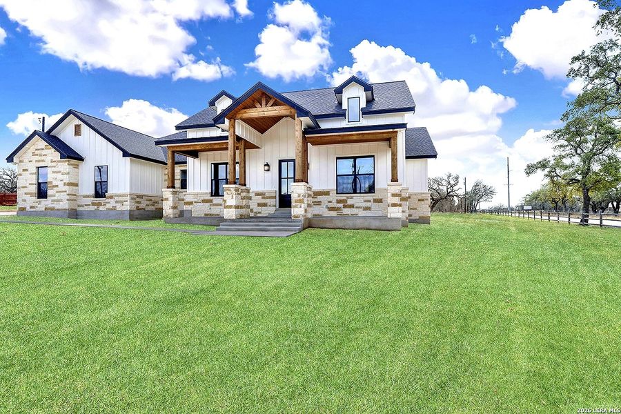 Front exterior of a new home in , La Vernia, TX, highlighting curb appeal (Image 26).