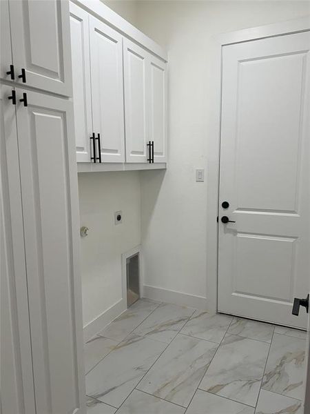 Laundry area featuring cabinets and electric dryer hookup