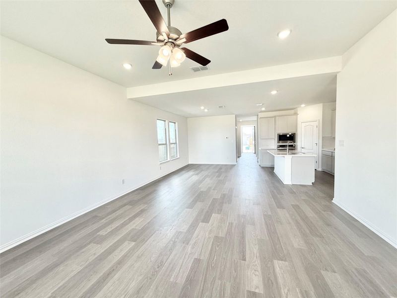 Unfurnished living room featuring recessed lighting, light wood-style floors, and ceiling fan Unfurnished living room featuring recessed lighting, light wood-style floors, and ceiling fan