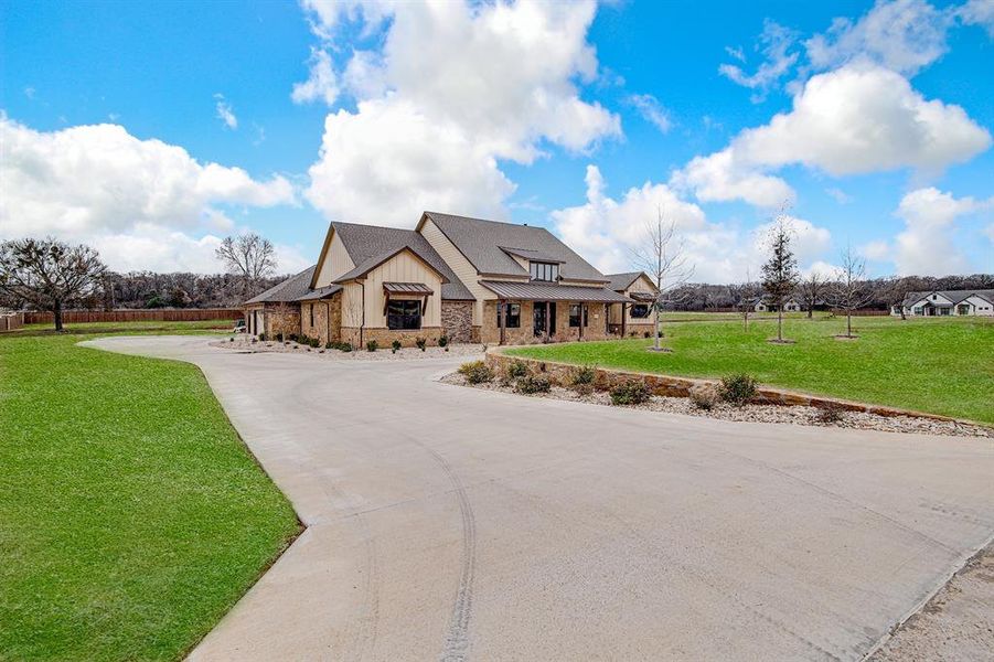 View of front of house featuring a circle driveway & 3 Car Oversized Garage View of front of house featuring a circle driveway & 3 Car Oversized Garage