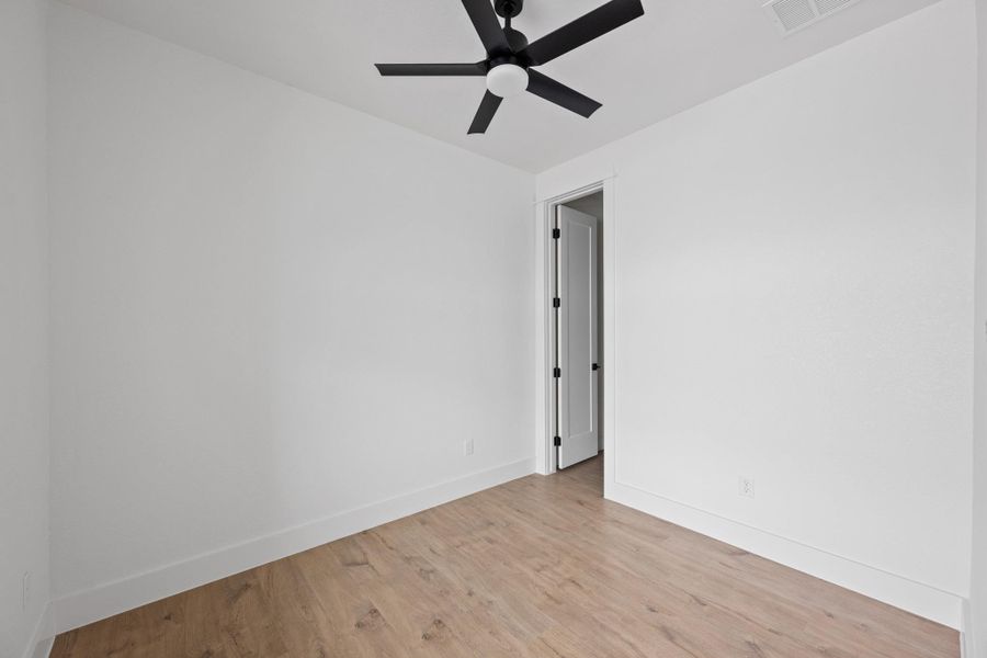 White interior walls with wood-finish flooring