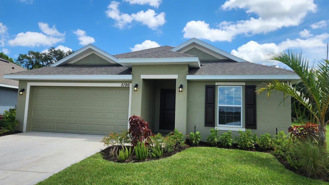 Front exterior of a new home in Waterstone 52, Fort Pierce, FL, highlighting curb appeal (Image 14).