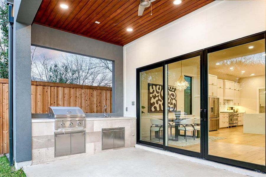 View of patio / terrace with an outdoor kitchen, a grill, sink, and ceiling fan