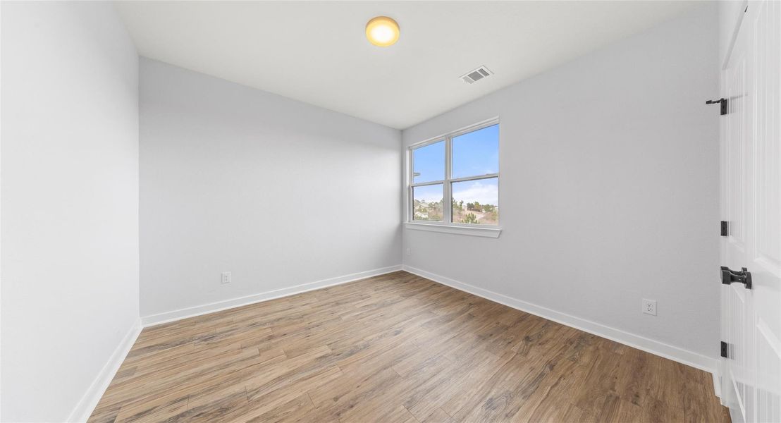 Empty room featuring light wood-style flooring and baseboards